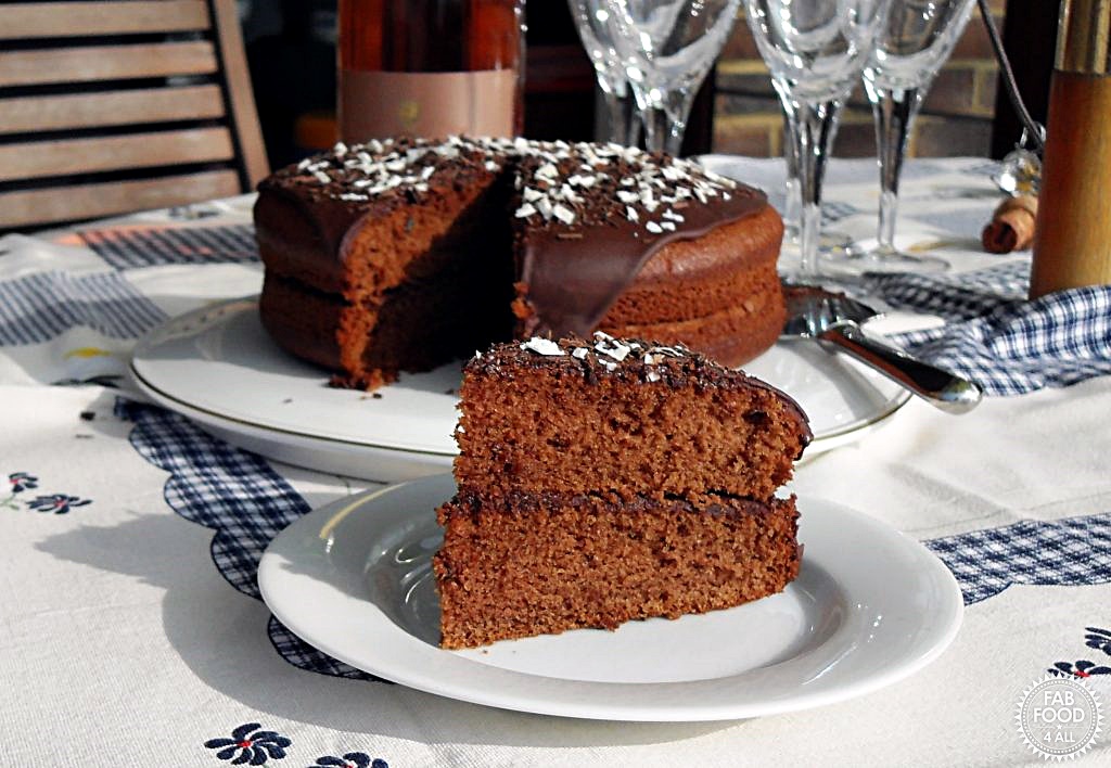 Olive Oil Chocolate Cake with slice on plate.