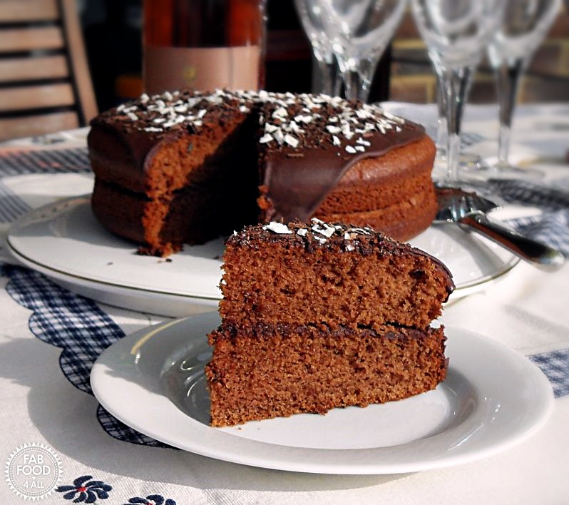 Olive Oil Chocolate Cake with slice on plate.