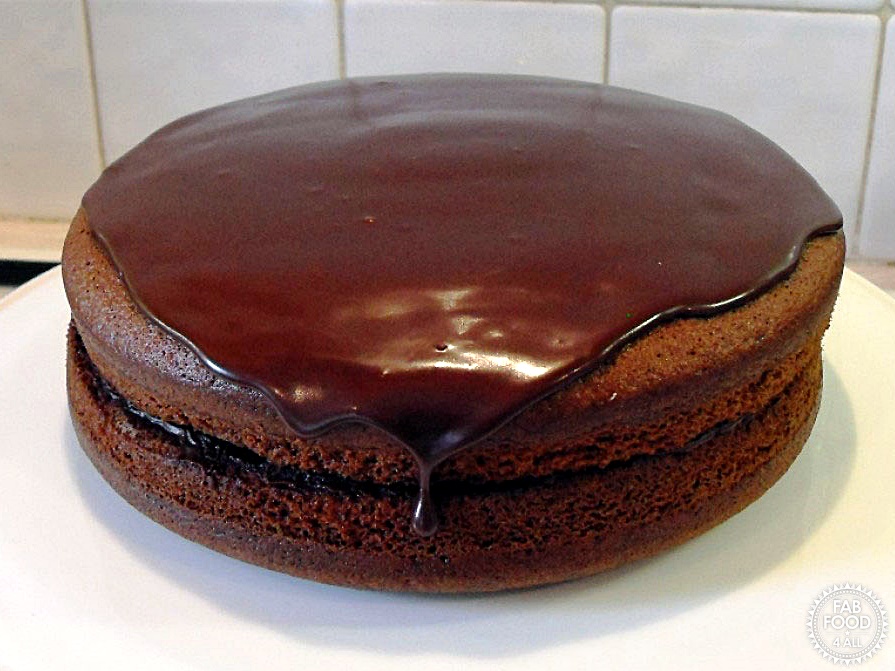Olive Oil Chocolate Cake with hot chocolate fudge frosting applied.