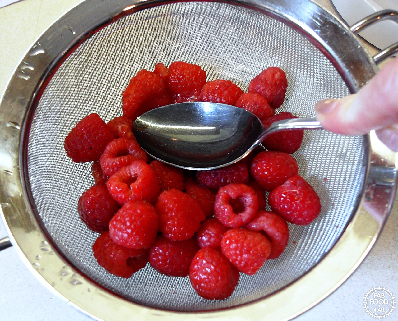 Raspberries being sieved.