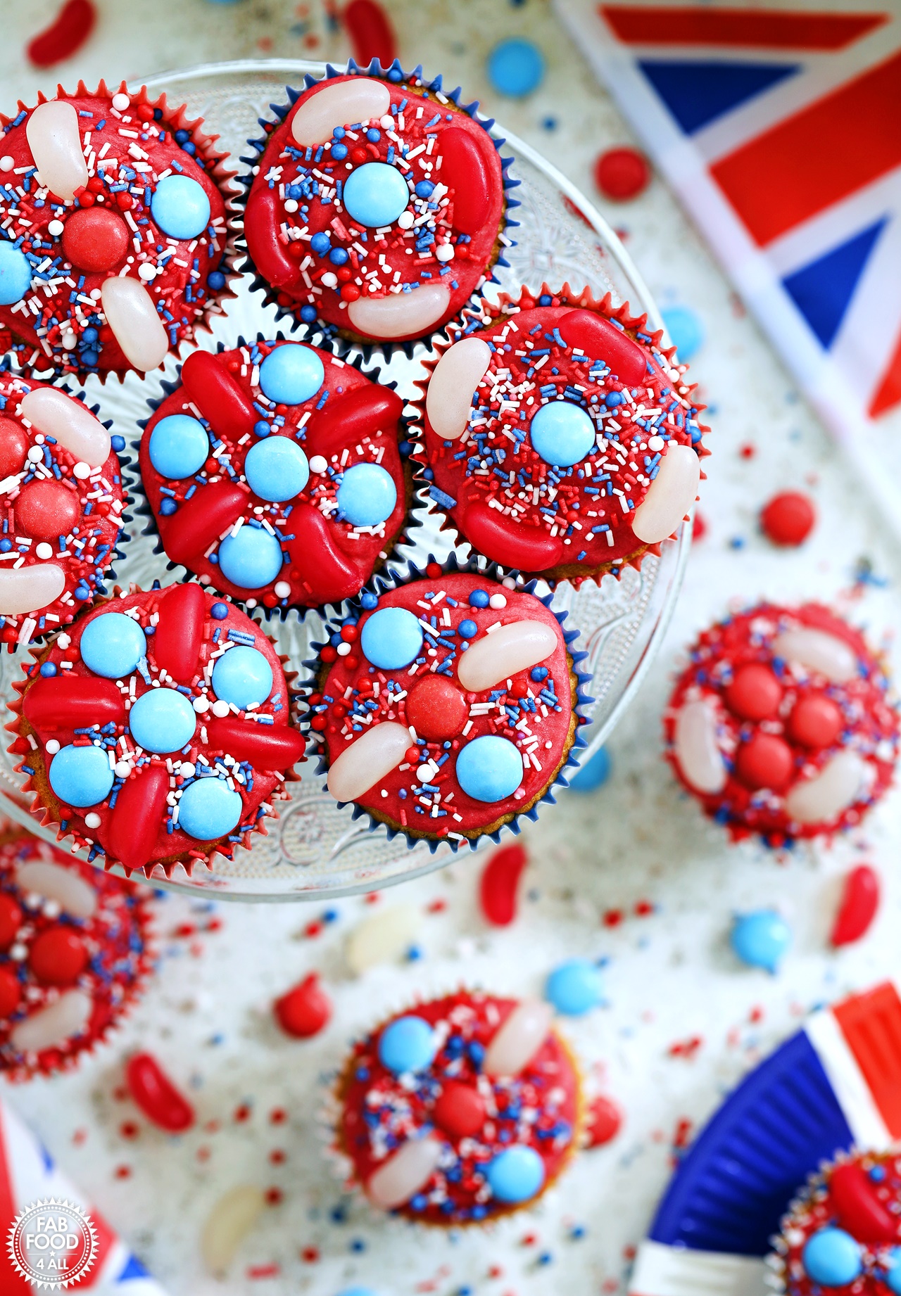Aerial view of Jubilee Cupcakes on a cake stand with Union Jack flag and plate.