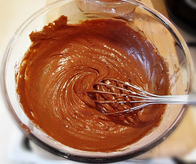 Chocolate Puddle Pudding batter in a bowl with whisk.