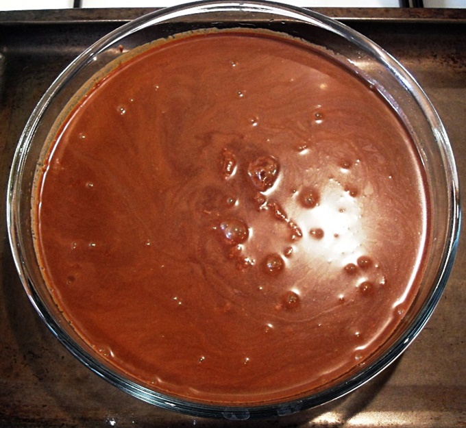 Chocolate Puddle Pudding batter in a round shallow glass baking dish.