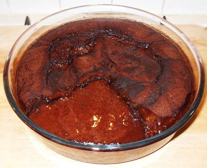 Chocolate Puddle Pudding with a slice missing showing the chocolate sauce.