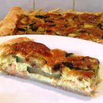 Salmon, Courgette and Shallot Quiche slice on a plate.