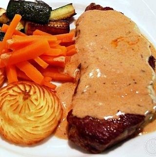 Steak with Whisky Sauce plated up with Duchess potatoes, carrots & fried courgettes.