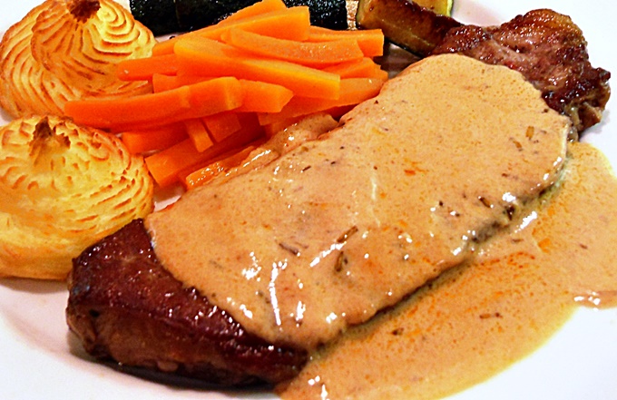 Steak with Whisky Sauce plated up with Duchess potatoes, carrots & fried courgettes.