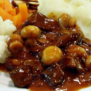 Beef in Beer served with vegetables and mashed potato.