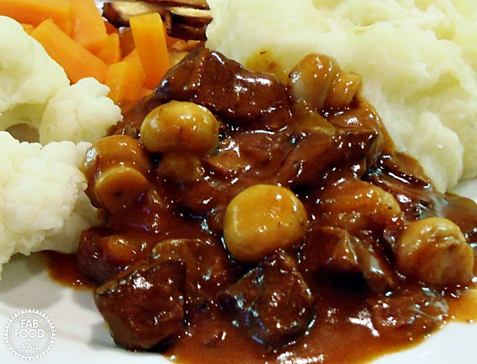 Beef in Beer served with vegetables and mashed potato.