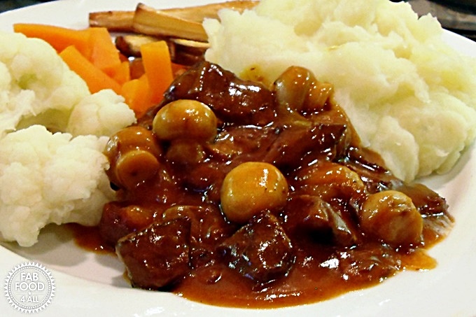 Beef in Beer served with vegetables and mashed potato.