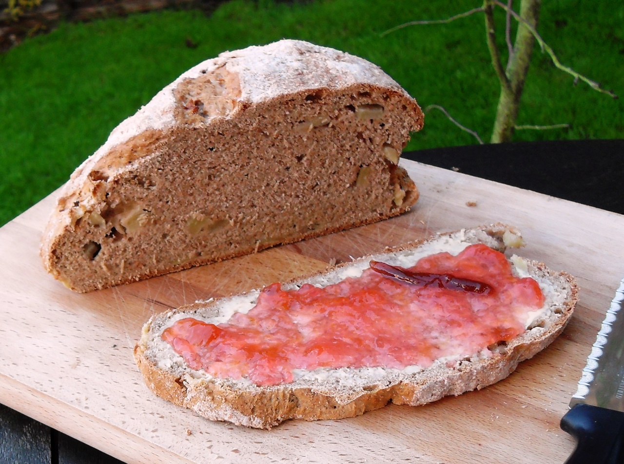 Apple & Pear Cider Spelt Soda Bread with slice buttered and spread with jam