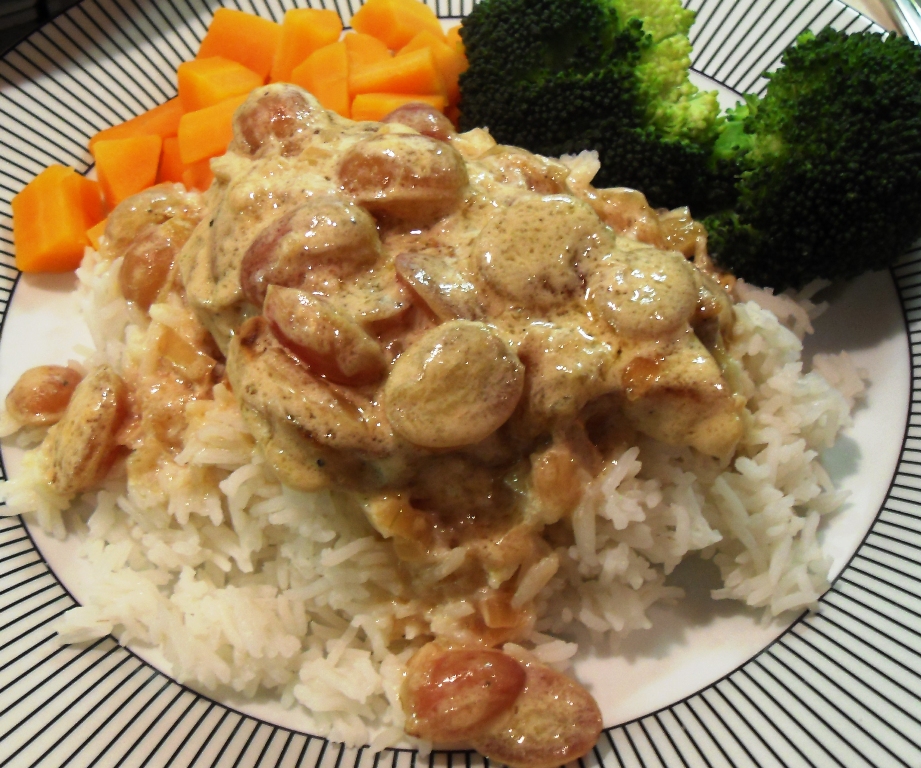 Pork in Grapes on a bed of rice with vegetables.