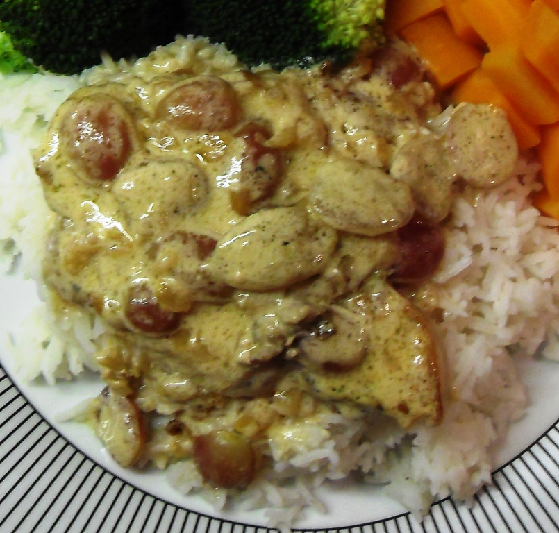 Pork in Grapes on a bed of rice with vegetables.