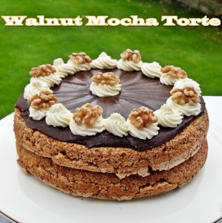 Walnut Mocha Torte on a platter with lawn in background.