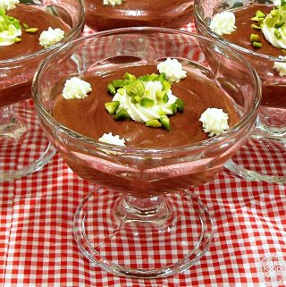 Chocolate & Pistachio Mousse in stemmed glass dishes.