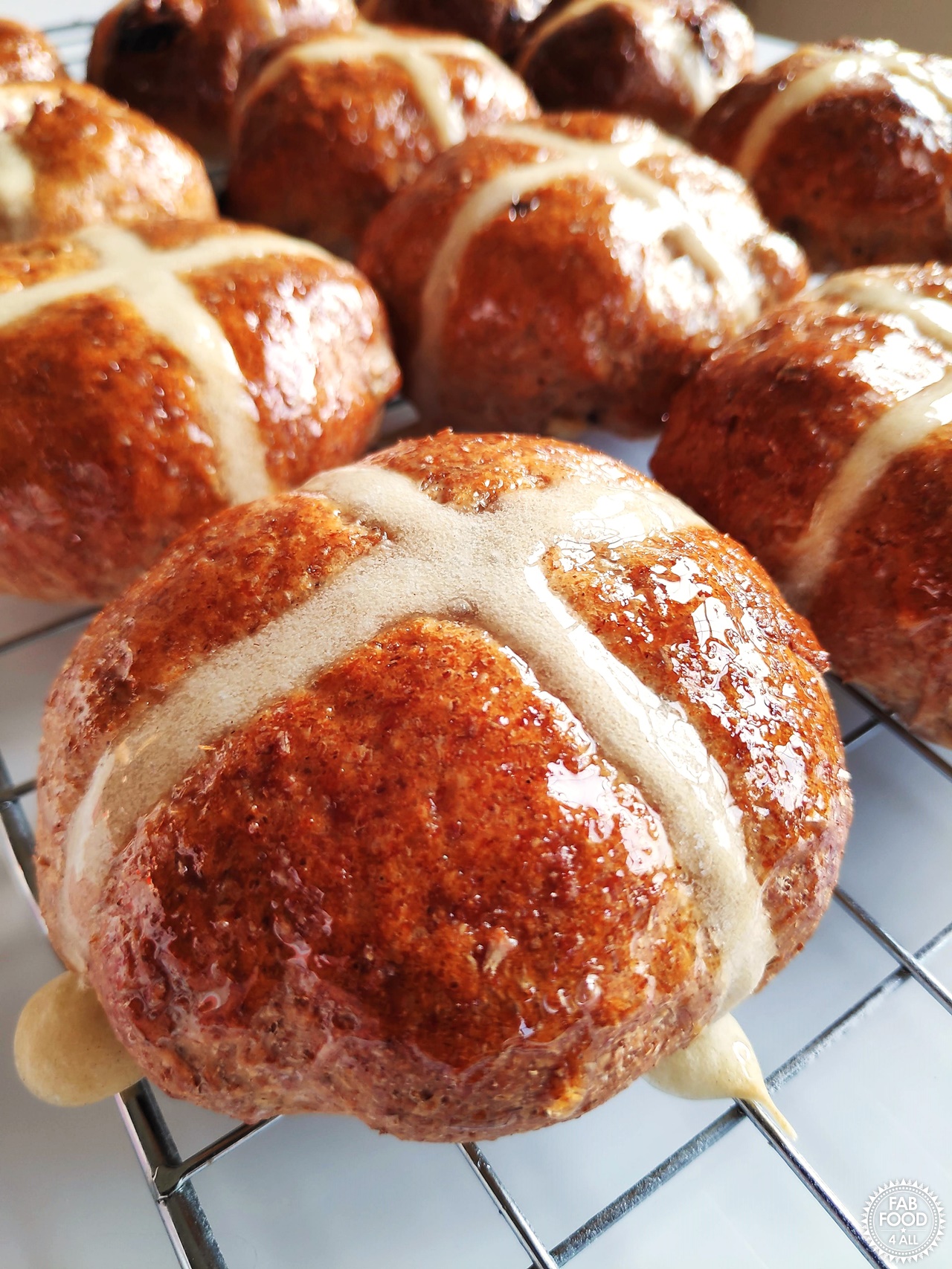 Wholemeal Hot Cross Buns on a wire rack.