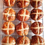 Wholemeal Apple Hot Cross Buns on a wire rack - aerial view.