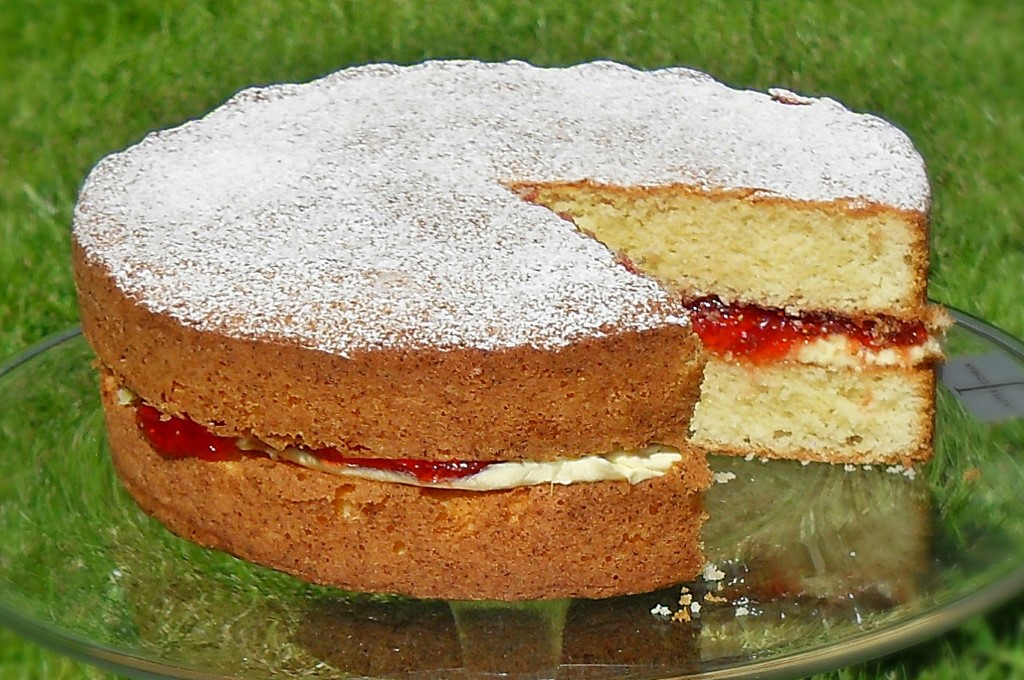 Victoria Sandwich on a pedestal with a slice cut out.