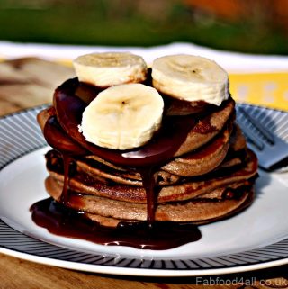 3 Ingredient Banana Nutella Pancakes stack topped with sliced banana.
