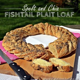 Spelt and Fishtail Plait Loaf in a wreath shape, cut with buttered slices.