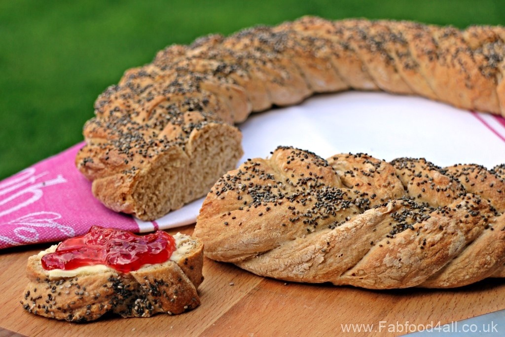 Spelt and Chia Fishtail Plait Loaf, with a slice buttered and spread with jam.