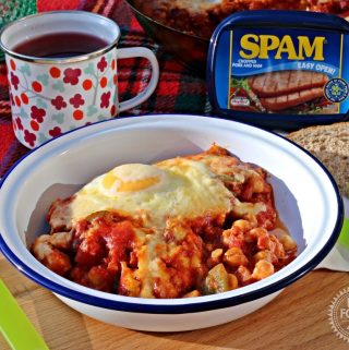 Chilli SPAM & Eggs aka SPAM Shakshuka in a tin camping bowl with mug and tub of SPAM in background.