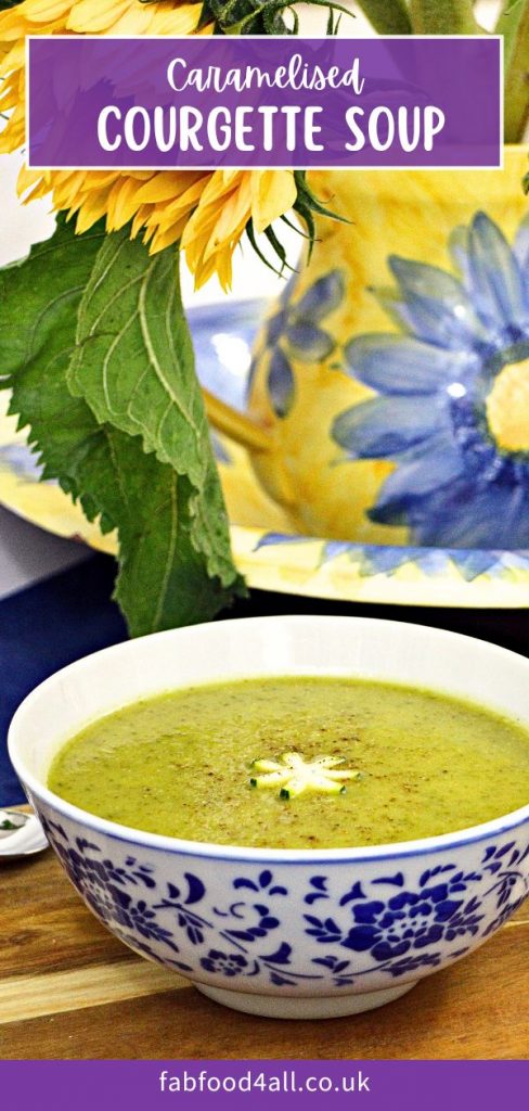 Caramelised Courgette Soup in a bowl with sunflower in jug behind it. Pinterest image.