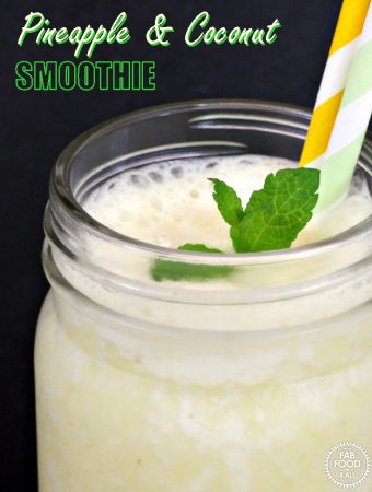Pineapple & Coconut Smoothie in glass mug with sprig of mint & 2 straws.