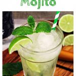 Non Alcoholic Mojito in a glass with crushed ice, stripey green straw, wedge of lime & spring of mint.