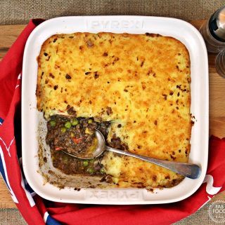 Easy Cheesy Cheat's Cottage Pie in a serving dish with spoon.