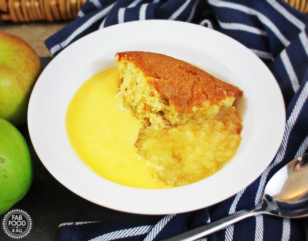 Eve's Pudding in a bowl with custard.