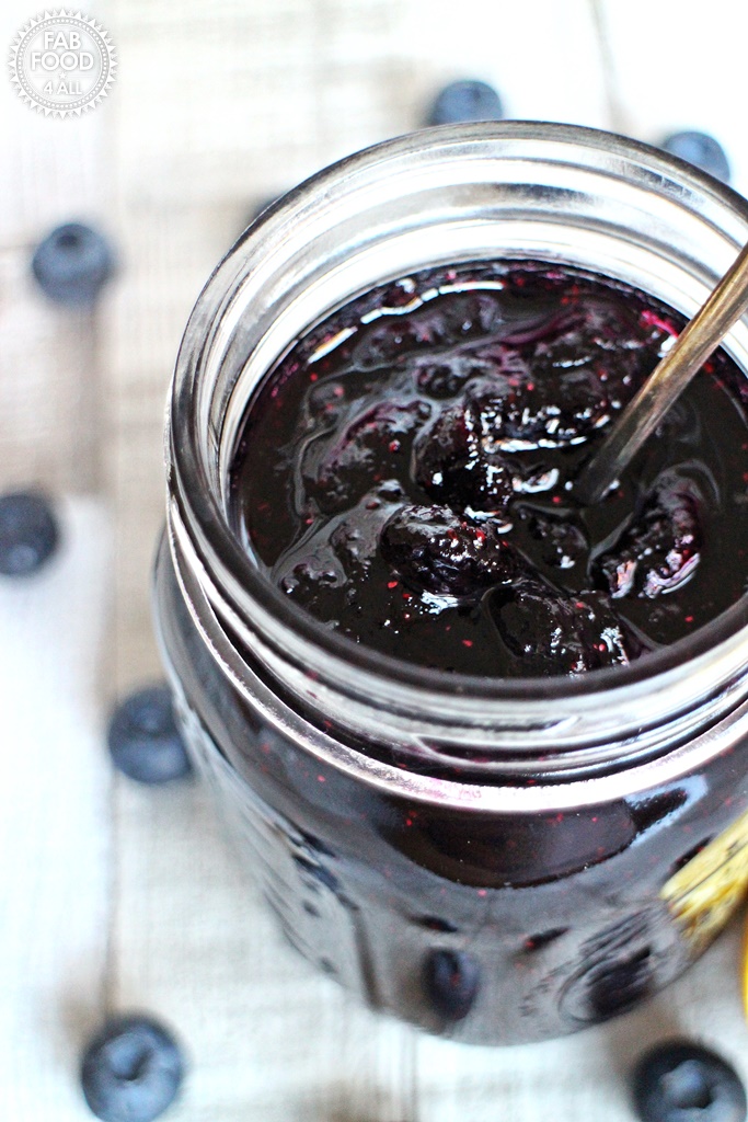 Simple Blueberry Jam in a jar with teaspoon.