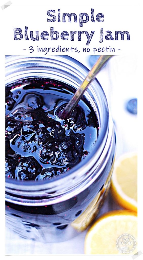 Close up of Blueberry Jam in a jar with a cut lemon. Pinterest image.