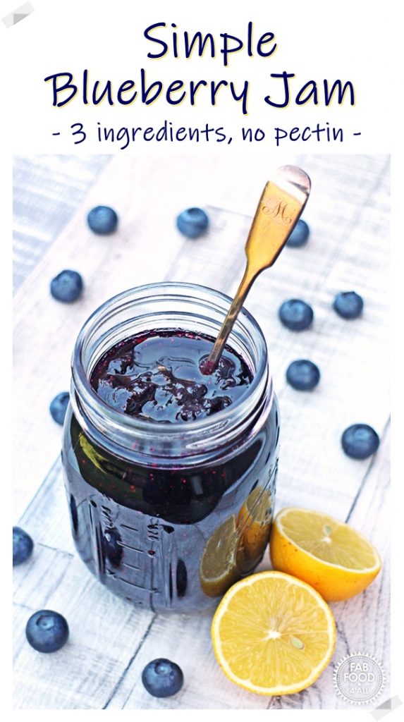 Simple Blueberry Jam in a jar with a cut lemon. Pinterest image.