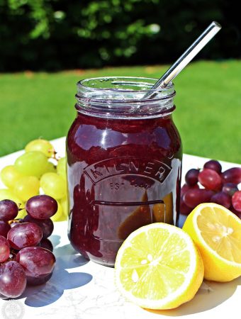 Easy Grape Jam with grapes & a cut lemon.