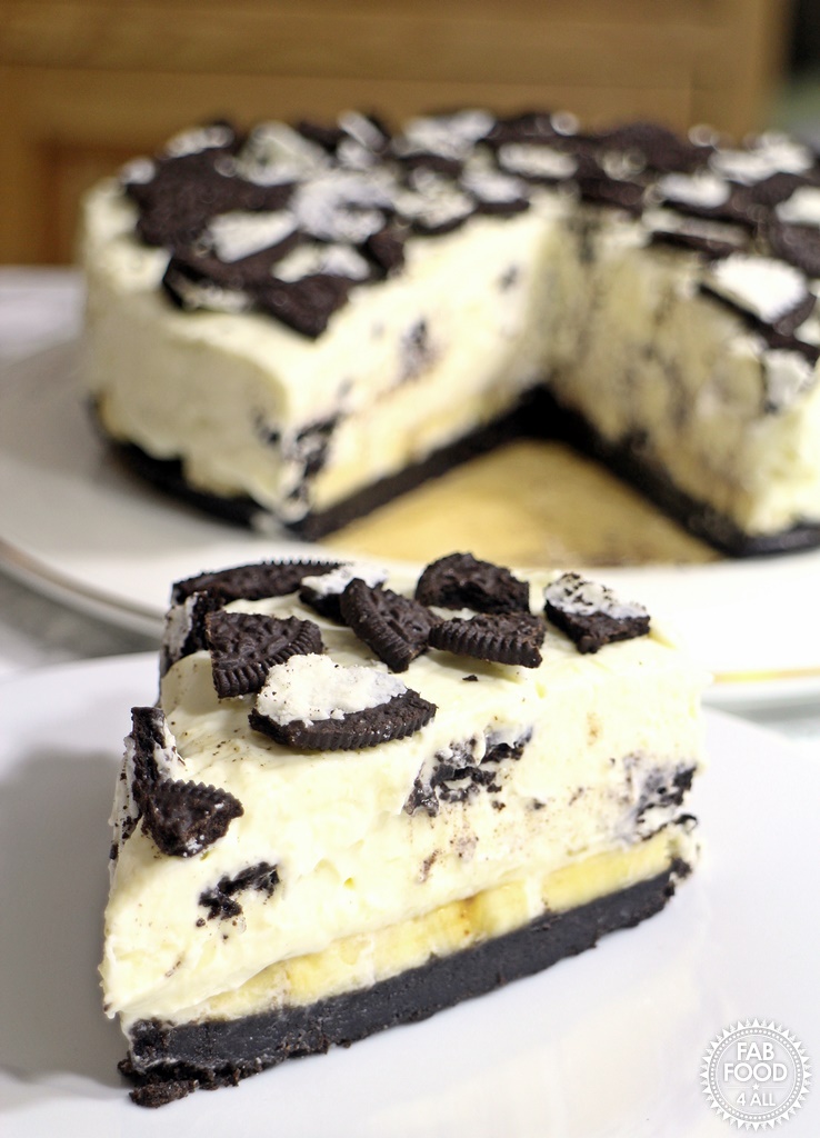 Banoreo Cheesecake with cut slice on a plate.