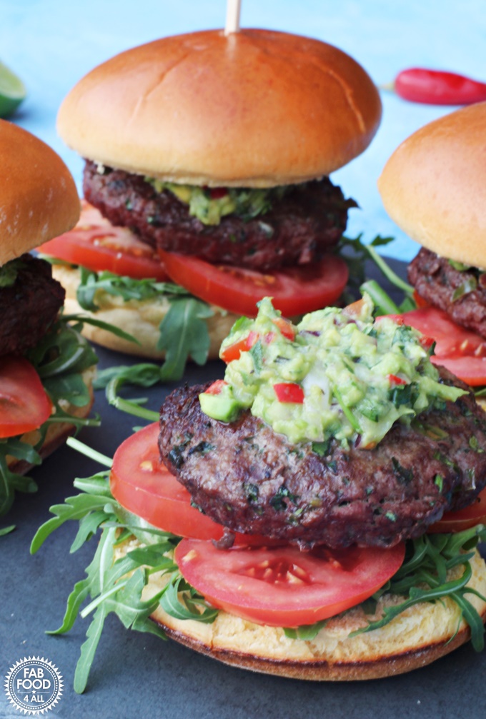 BBQ Chilli Burgers with Guacamole on a slate.