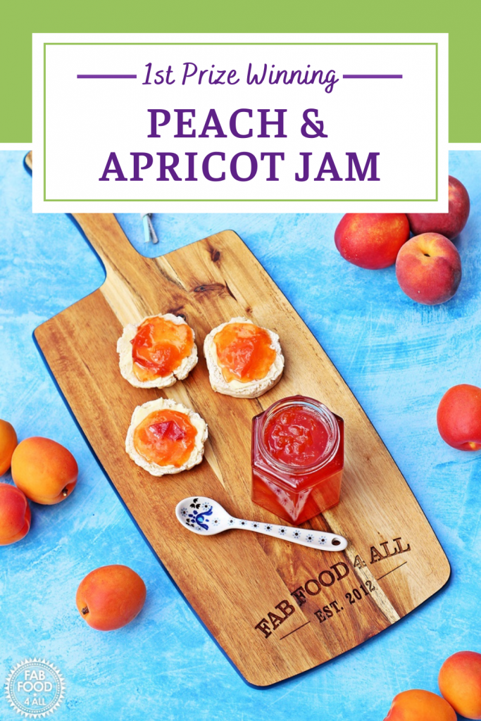 Jar of Peach & Apricot Jam with a spoon and scones on a wooden board surrounded by peaches, nectarines and apricots. Pinterest image.