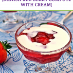 Rødgrød med fløde (Danish Red Berry Compote with Cream) in a glass sundae dish. Pinterest image.