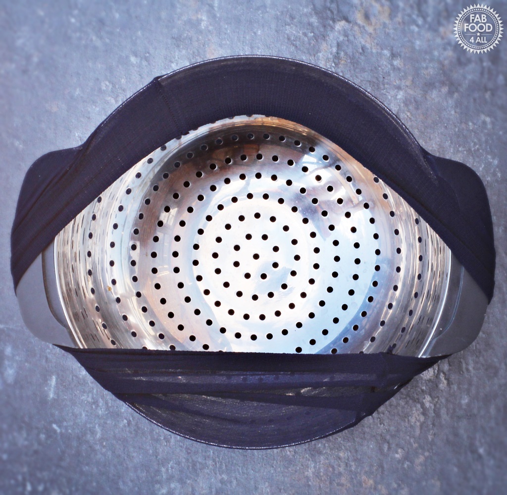 Colander with tights for use as muslin when straining jelly.