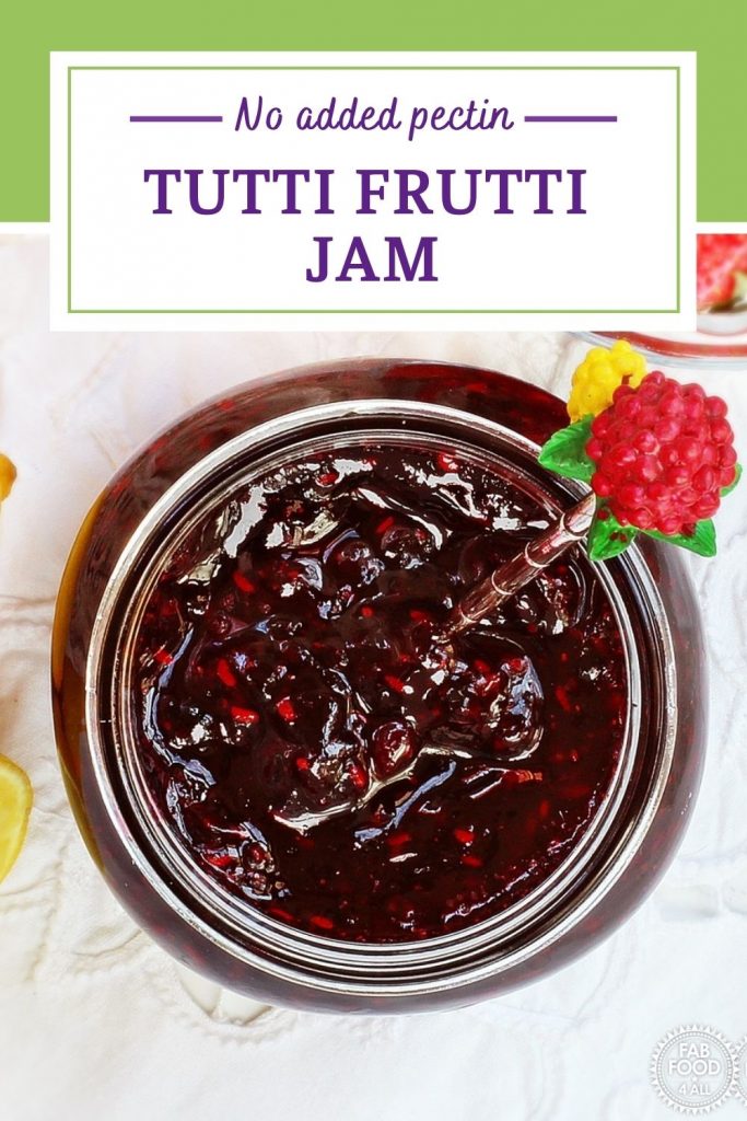 Tutti Frutti Jam in a jar with berries in background Pinterest image.