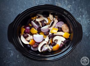 Chicken thighs, red onion, chestnut mushroom & yellow peppers in slow cooker.