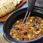 Easy Slow Cooker Vegan Stew - a hearty, tangy stew with root vegetables, Chestnut mushrooms & peas. Serve with crusty bread to mop up the cooking juices! #slowcooker #crockpot