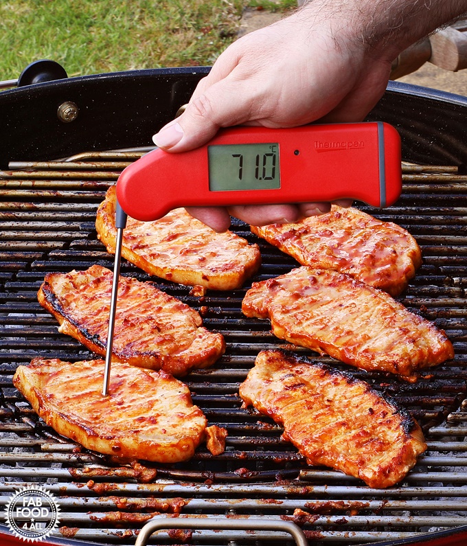 Korean BBQ Style Spicy Pork on the BBQ being temperature probed with the Thermapen Professional.