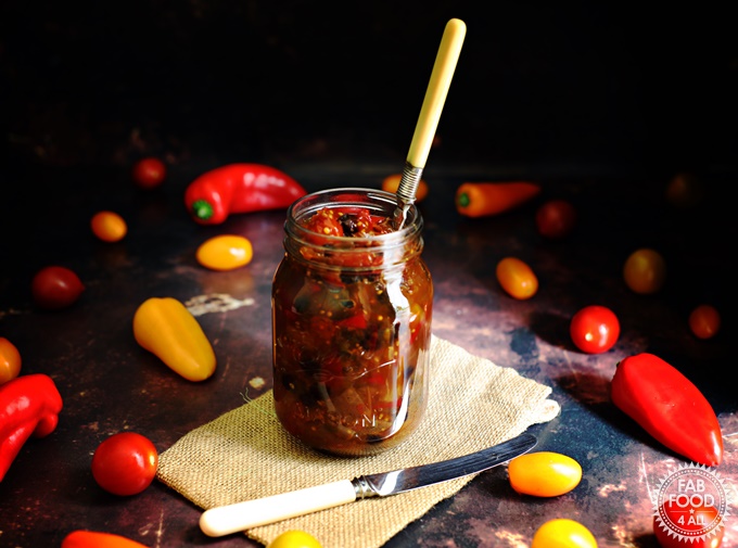 Spicy Baby Tomato & Sweet Pepper Chutney in a jar with fork in it.
