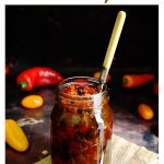 Spicy Baby Tomato & Sweet Pepper Chutney in a jar with fork in it.