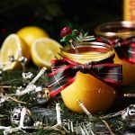 Snowball Curd with teaspoon, lemons, Christmas tree branches & fairy lights.
