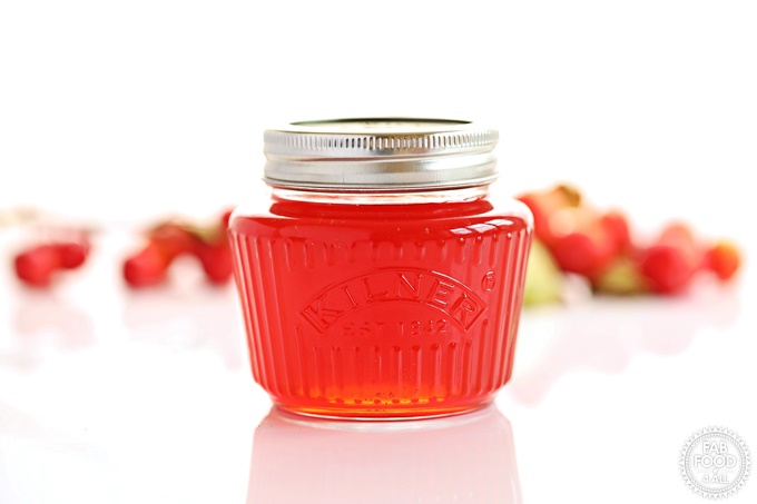 Landscape shot of jar of Crab Apple Jelly with branch in background.