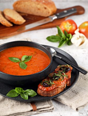 Roasted Tomato & Garlic Soup with Basil in a bowl with pizzetta toast.