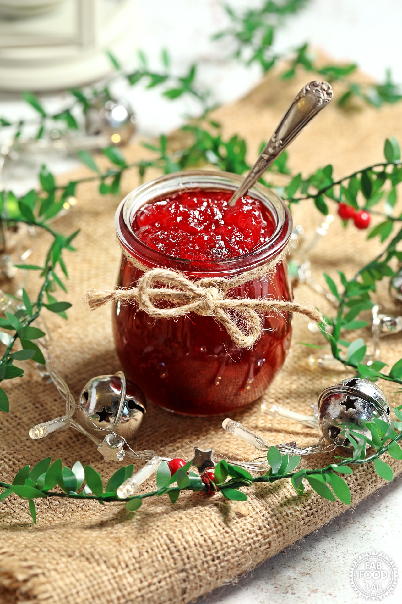 Christmas Jam in Weck jar with teaspoon with festive lights and decor.